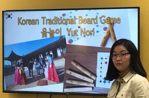 Korean teacher explains rules of traditional Lunar New Year game, Yut Nori.