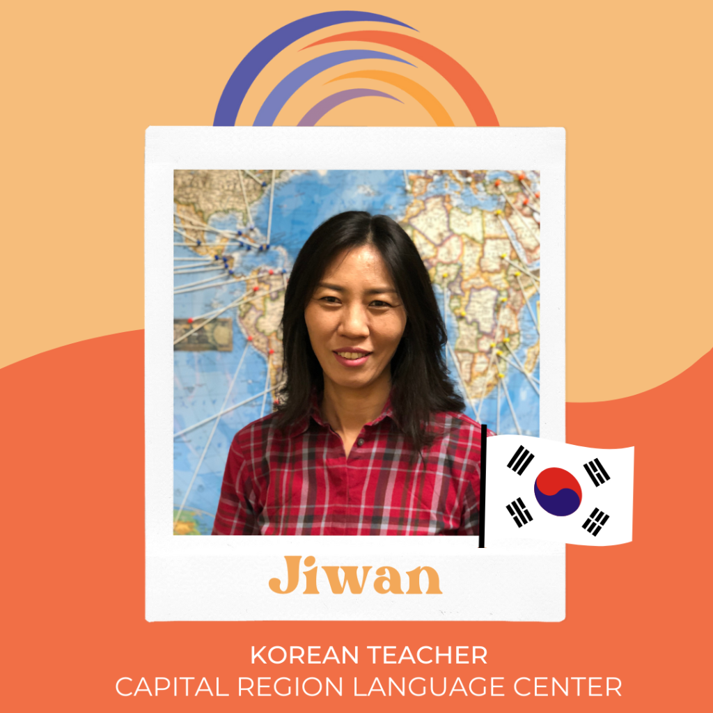 Photo of Jiwan Park, Korean language teacher at Capital Region Language Center, with Korean flag.