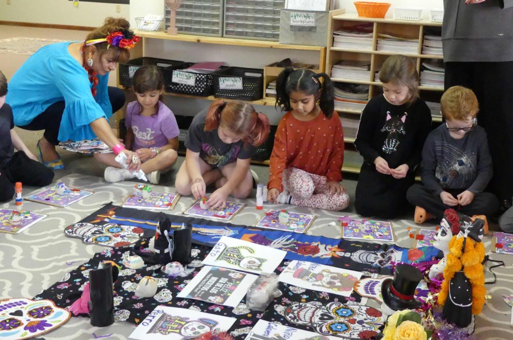 Children at Malta Montessori, sit on the carpet and decorate calaveras de azúcar or sugar skulls, in honor of Día de los Muertos, or Day of the Dead.