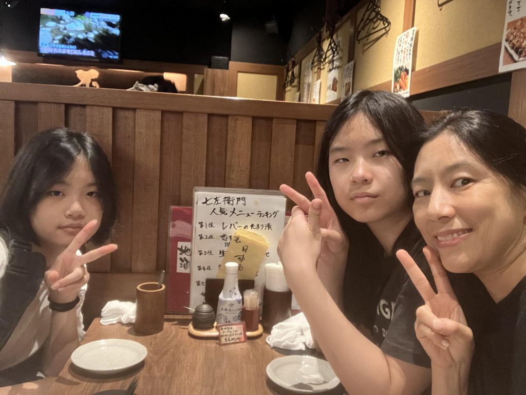 Mother and daughters eating at a restaurant.