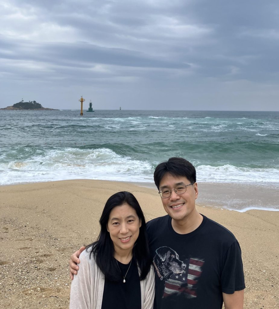Man and woman standing at the beach.
