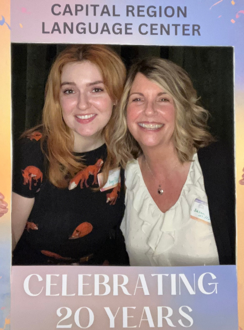 Two women smiling in a selfie frame, that says "Capital Region Language Center Celebrating 20 years"