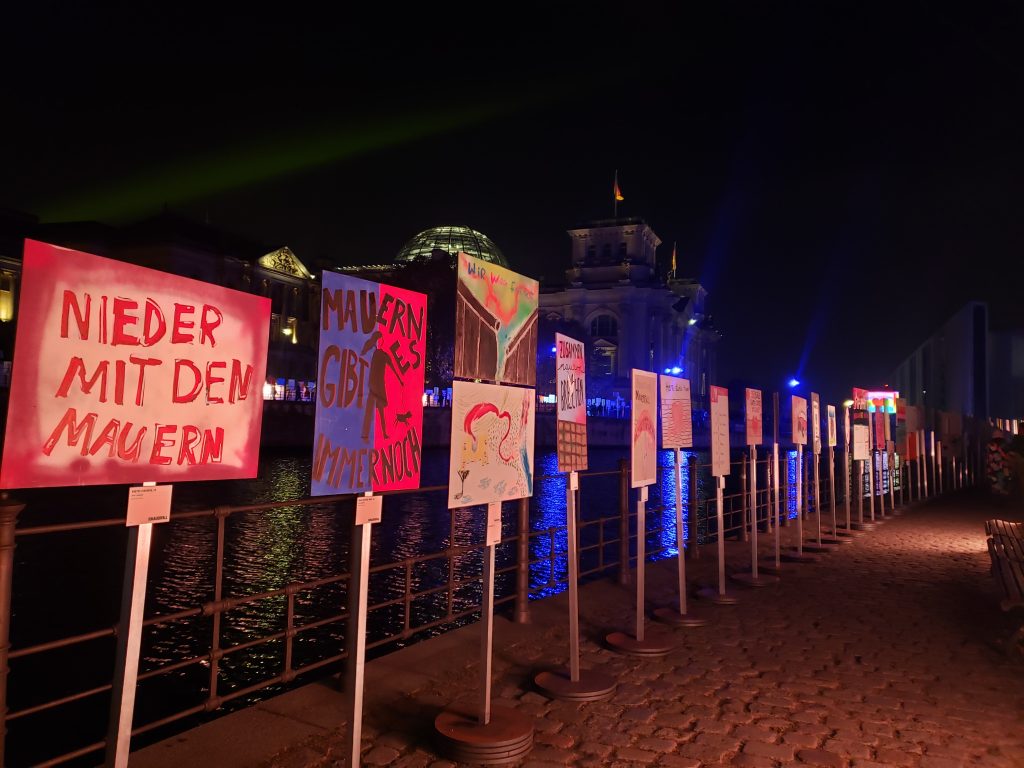 Signs and art lined up where the Berlin Wall once stood in Germany.